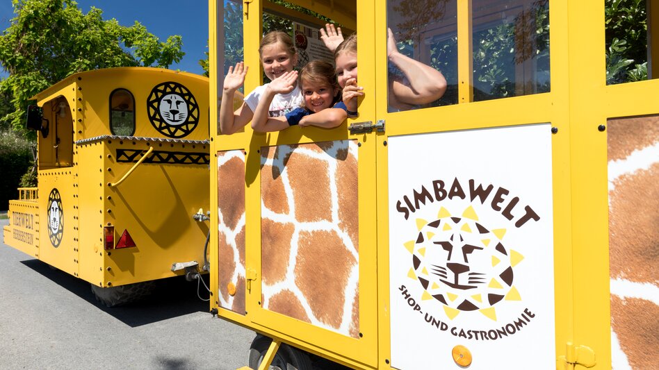 Kinder winken aus dem Bummelzugfenster heraus