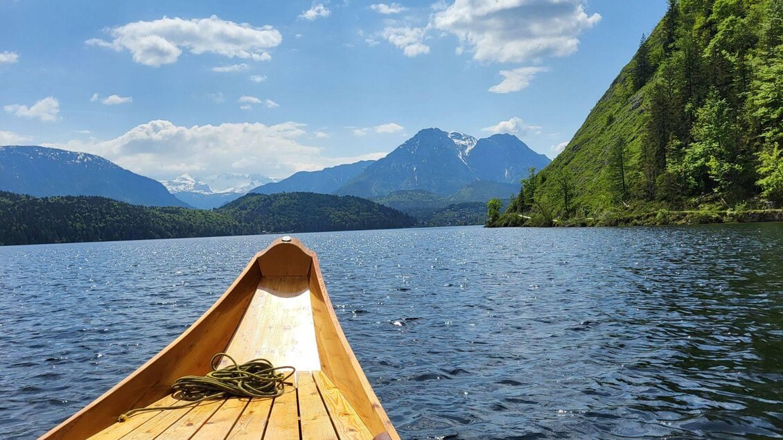 Ein Blick von einem Boot auf einen ruhigen See umgeben von hohen Bergen. Der Himmel ist klar und blau mit einigen Wolken. | © TVB Ausseerland Petra Kirchschlager