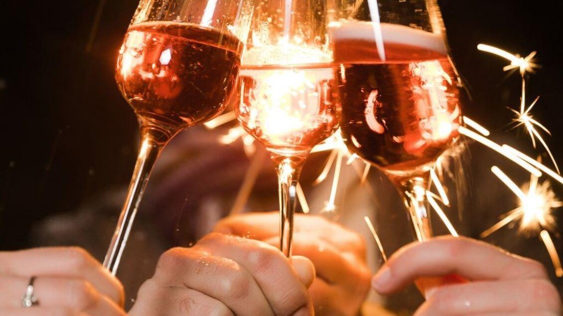 Ein festlicher Toast mit Sektgläsern, die funkelnde Wunderkerzen halten. Die Atmosphäre ist fröhlich und feierlich. | © TV Südsteiermark - Lupi Spuma