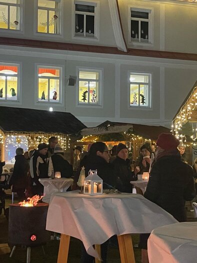 A festively decorated Christmas market with many people. The stalls are adorned with lights, creating a cozy atmosphere. | © Marktgemeinde Wies