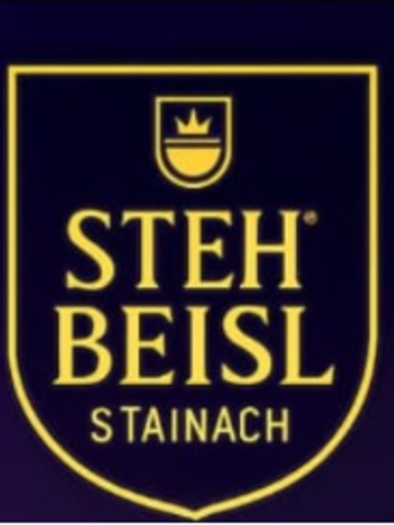 Logo in a gold-bordered shield on a dark background; within the shield are the words "STEH BEISL STAINACH" and above it is a small symbol featuring a stylized crown.