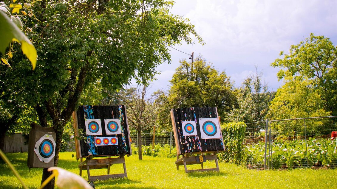 Zwei Zielscheiben stehen in einem grünen Garten unter Bäumen. Der Himmel ist teilweise bewölkt und es ist eine friedliche Atmosphäre. | © Janis Deutsch