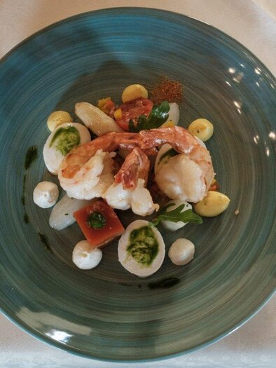 An elegant dish with shrimp, fresh vegetables, and sauces on a stylish plate. The appealing presentation invites to indulge. | © Schilcherland Steiermark