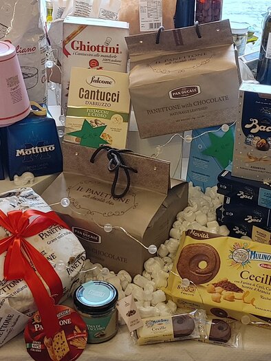 A variety of Italian sweets and snacks is presented in an appealing arrangement.  
Different packaging and products are clearly visible, including cookies, chocolates, and desserts. | © DaContini