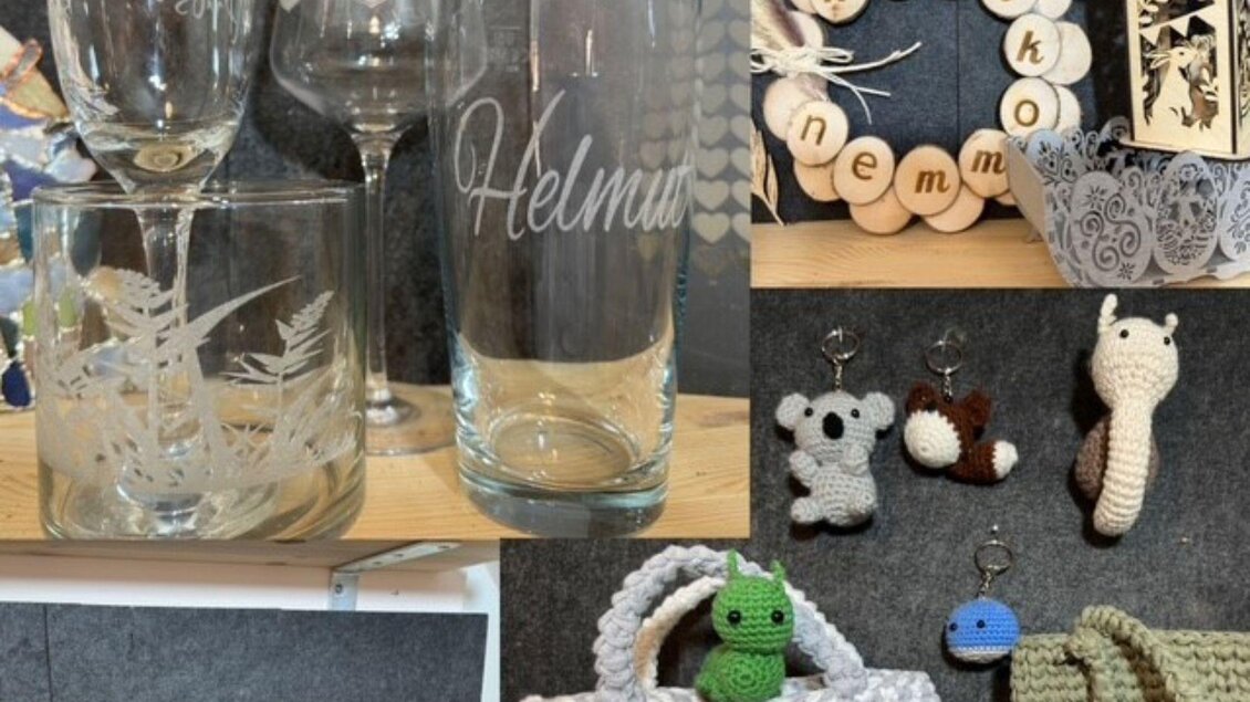 Eine Sammlung von handgefertigten Kunstwerken, darunter gravierte Gläser, Schlüsselanhänger und gehäkelte Taschen. Verschiedene kreative Gegenstände zeigen kunsthandwerkliche Fähigkeiten. | © Angelika Mikula-Hubacek