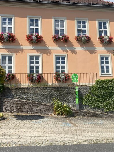 A picturesque church on a hill, surrounded by trees and green meadows. The warm colors of sunlight highlight the architecture of the building. | © Joachim Ruhri