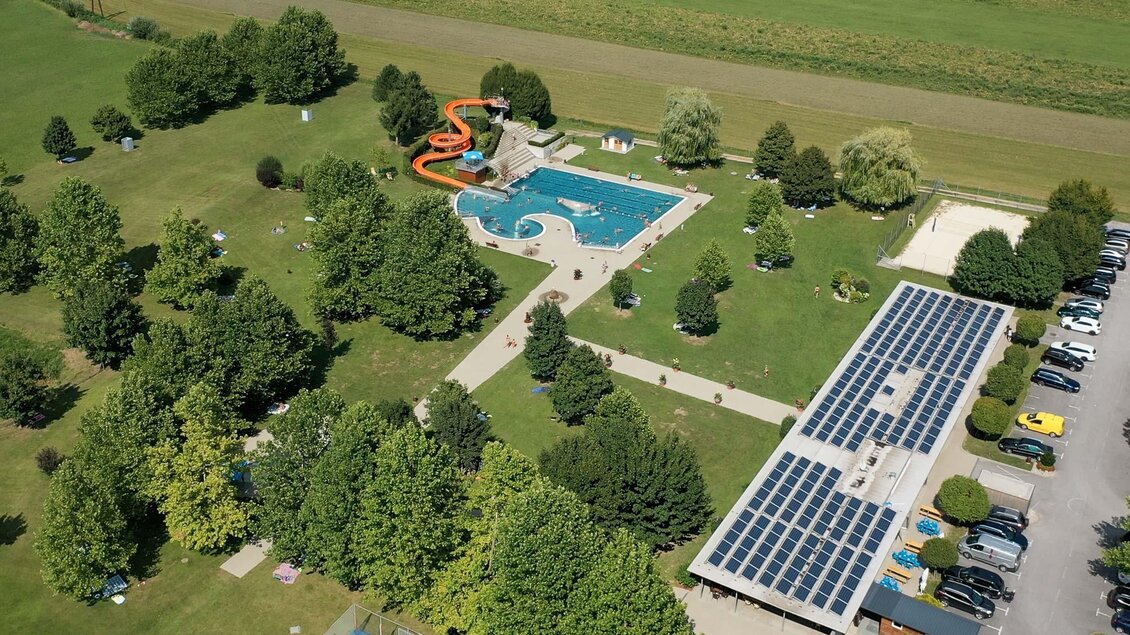 Ein schöner Außenbereich mit einem Swimmingpool und einer Wasserrutsche. Umgeben von Bäumen und einer langen Wiese. | © Netwerker