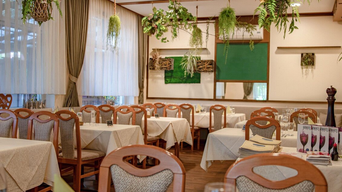 Ein gemütliches Restaurant mit Tischen und Stühlen, dekoriert mit Pflanzen. Die Wände sind hell und die Atmosphäre ist einladend. | © Gasthof s'Reindl