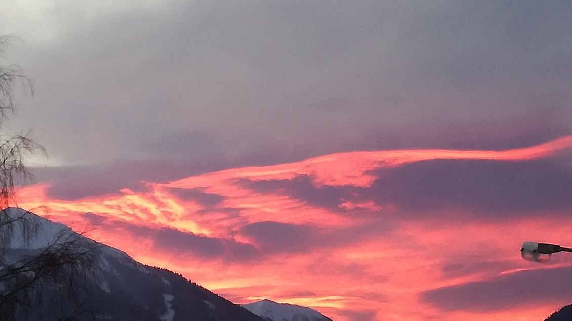 Ein schöner Sonnenuntergang über schneebedeckten Bergen. Die Wolken strahlen in lebhaften Pink- und Lila-Tönen. | © Gemeinde Mitterberg-Sankt Martin