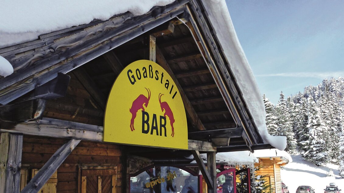 Eine gemütliche Bar im Schnee, umgeben von verschneiten Bäumen. Das Schild zeigt den Namen der Bar deutlich. | © Tourismusverband Murau