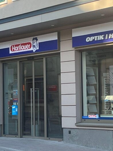 Eine malerische Stadt mit traditionellen Gebäuden und einer markanten Kirche. Im Hintergrund erstrecken sich sanfte Hügel und Berge unter einem blauen Himmel. | © TVB Ausseerland-Salzkammergut_Nathalie Schröttenhamer