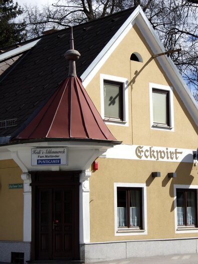 Ein gemütliches Gebäude mit einem roten Dach und gelber Fassade. An der Wand steht der Schriftzug „Eckwirt“ und es gibt ein paar Fenster in verschiedenen Größen. | © TV  Region Graz - Lunghammer