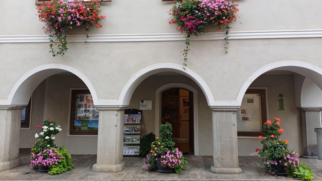 Eine schöne Fassade mit Bogenfenstern und blühenden Blumenkästen. Vor dem Gebäude stehen bunte Blumenkübel. | © TVB Südsteiermark - Irene Löschnig
