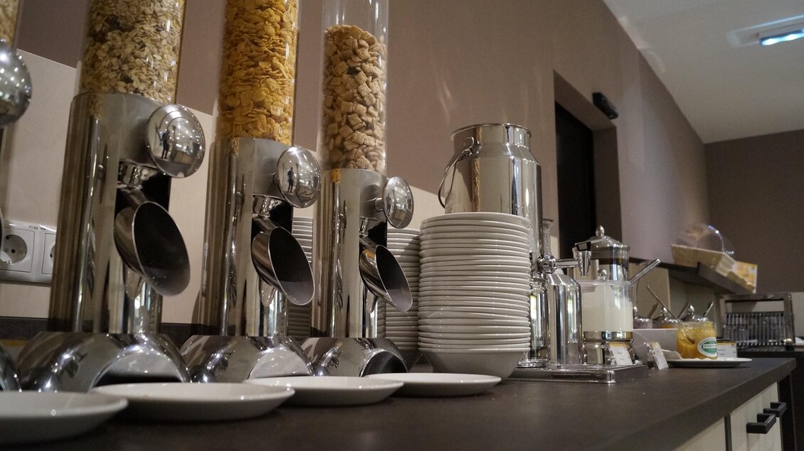  Müslispender, Tellerstapel, Milchkanne und Marmelade am Frühstücksbuffet. | © JUFA Hotels