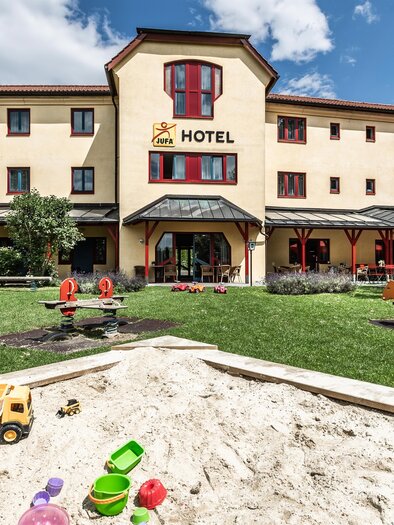 A family-friendly hotel with a large garden. The playground features play equipment and a sandpit. | © Lipizzanerheimat-Lenz