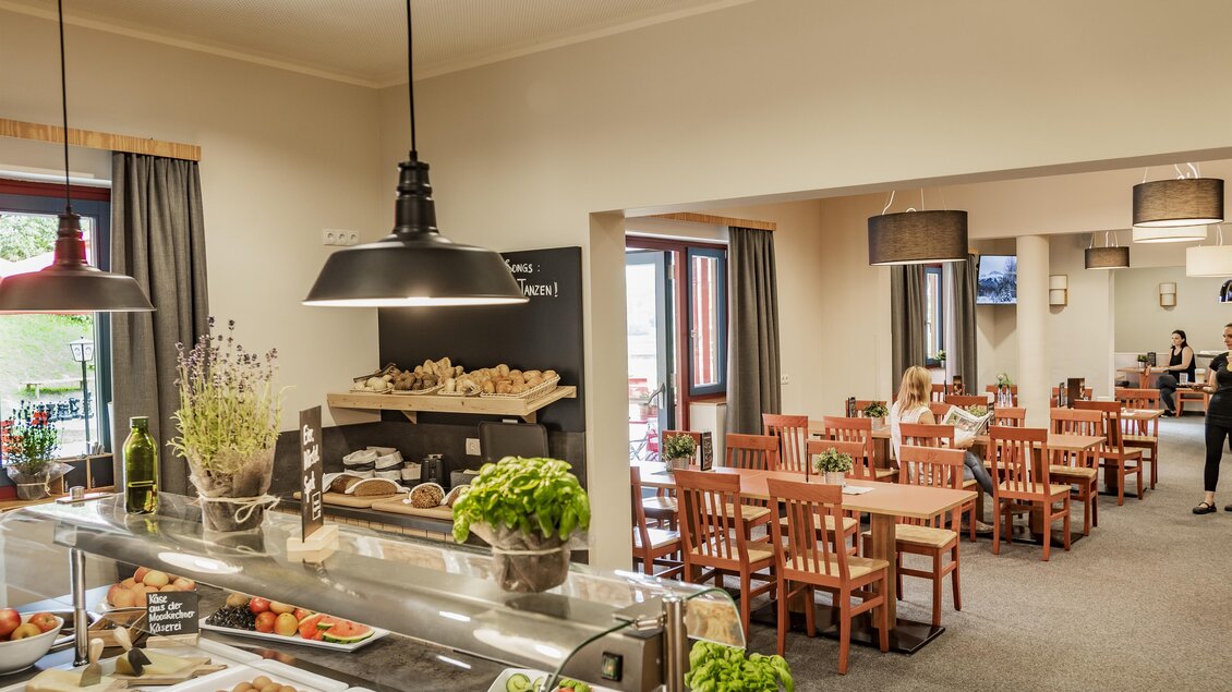 Ein gemütliches Restaurant mit Holzstühlen und einem Buffetbereich. Das Ambiente ist hell und einladend, perfekt für Mahlzeiten in angenehmer Atmosphäre. | © Lipizzanerheimat-Lenz