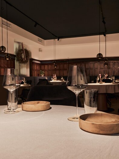A stylish restaurant with elegant tables and beautiful decorations. The warm lighting creates an inviting atmosphere.