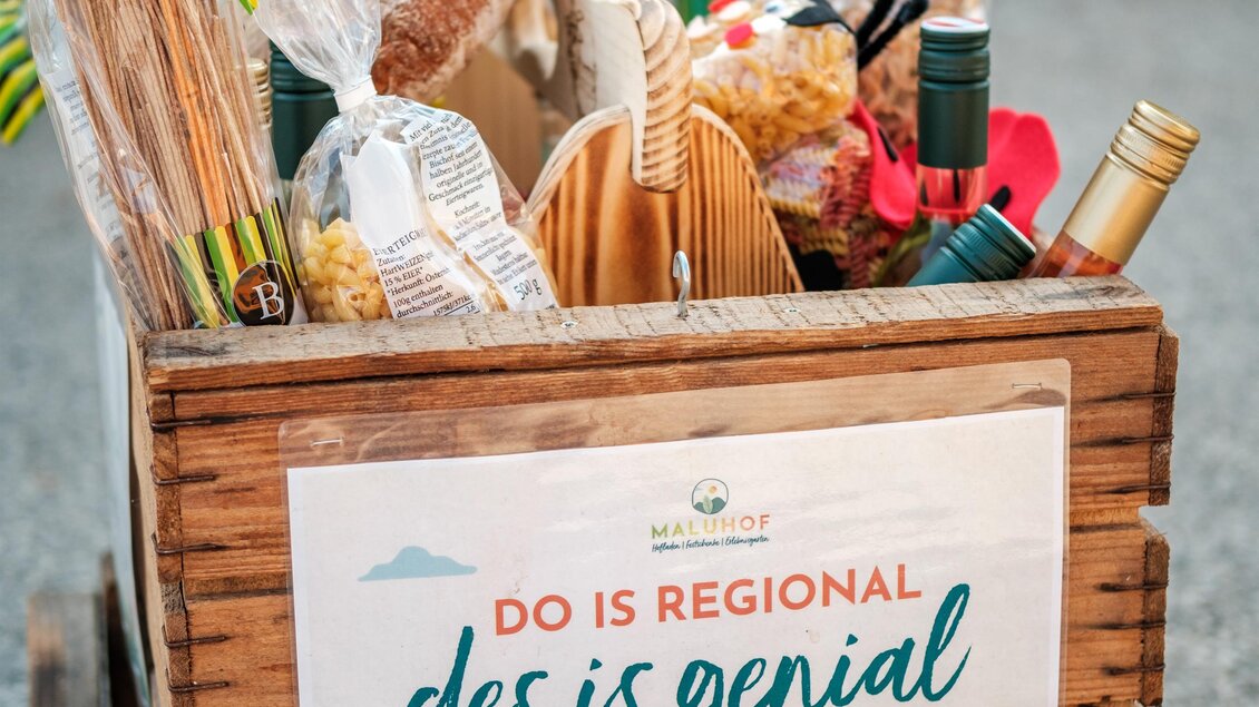 Ein Holzwagen mit regionalen Lebensmitteln und Produkten. Auf dem Wagen befindet sich ein Schild mit dem Slogan „DO IS REGIONAL des is genial“. | © MALU