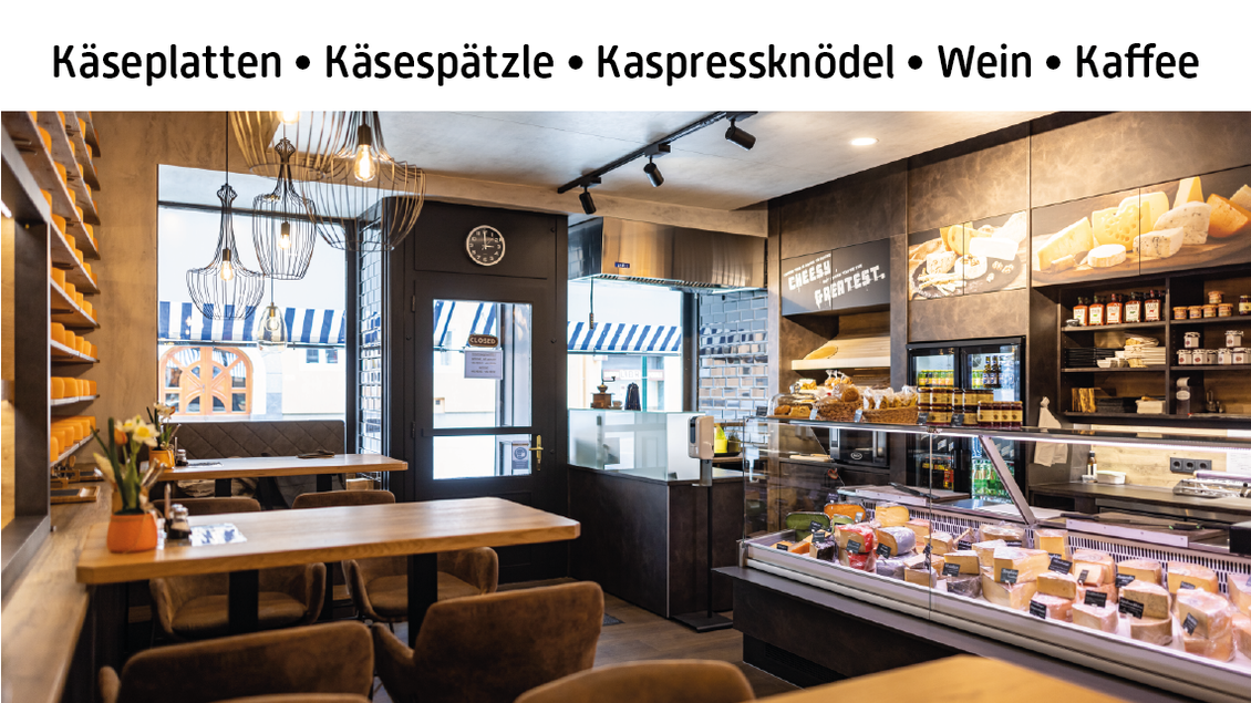 Ein einladendes Käseladeninnere mit gemütlicher Atmosphäre und einer großes Auswahl an Käse und Snacks. Die Ladeneinrichtung ist modern und einladend gestaltet.