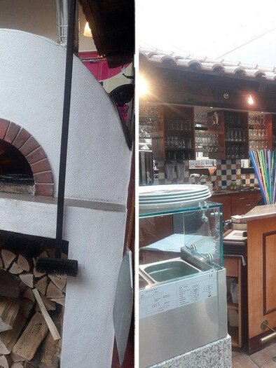 Ein traditioneller Pizzaofen mit brennendem Holz, links im Bild. Rechts ein einladender Barbereich mit Holzstühlen und einer gut gefüllten Theke. | © Pizzeria Ristorante La Piazza