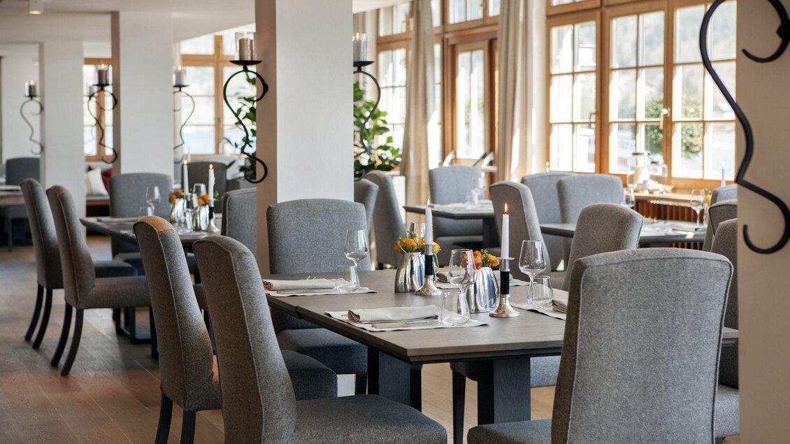 Ein elegantes Restaurant mit hellen Fenstern und modernem Interieur. Die Tische sind stilvoll gedeckt und laden zum Essen ein. | © Seehotel Grundlsee