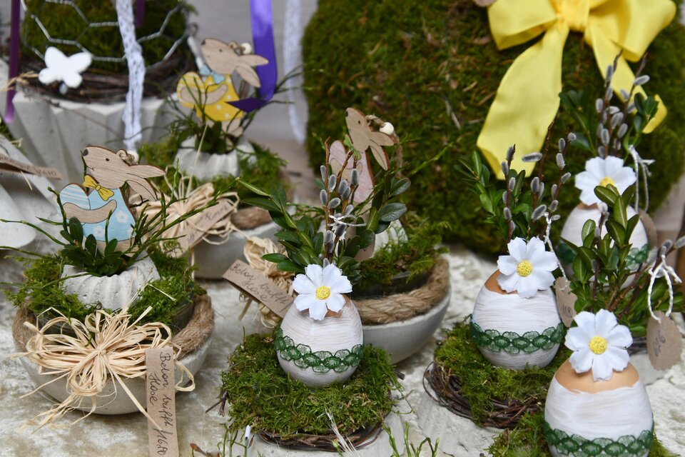 Dekorative Ostereier in verschiedenen Töpfen mit frischem Moos und kleinen Blumen. Einige Töpfe sind mit Papierfiguren von Hasen geschmückt. | © Thermen- & Vulkanland