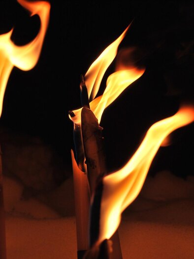 Flackernde Flammen von brennenden Kerzen vor dunklem Hintergrund. Die lodernden Flammen erzeugen eine gemütliche und warmherzige Atmosphäre. | © pixabay.com