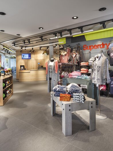 A modern retail store with a variety of clothing and accessories.  
Shelves are well organized and provide an inviting atmosphere. | © Bründl Sports / Christian Wöckinger