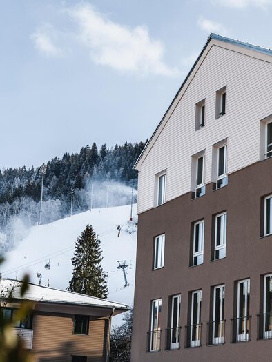 JUFA Hotel visible with a snowy landscape in the background | © JUFA Schladming