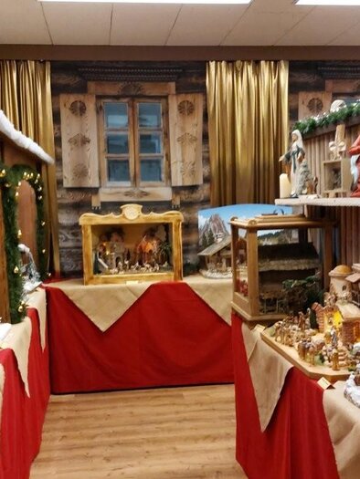 Ein festlich dekorierter Raum mit Weihnachtskrippen und Figuren. Die Wände sind mit Holz verkleidet und es gibt weihnachtliche Beleuchtung. | © Gerald Gerhardter
