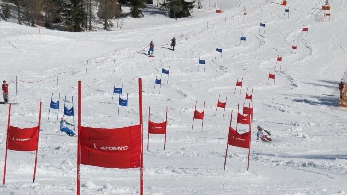 Eine Skipiste mit roten und blauen Toren im Schnee. Im Hintergrund sind Skifahrer und Bäume zu sehen. | © Galsterberg/ SV Pruggern