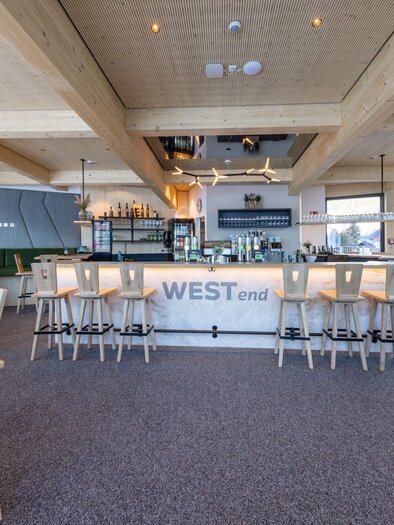 A modern restaurant with a bright, inviting atmosphere.  
Wood details and high windows create a pleasant environment. | © Harald Steiner